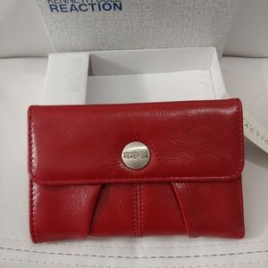 Kenneth Cole Reaction red wallet snap closure.